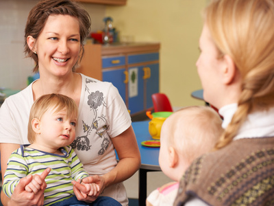 Two Mothers With Chidren Chatting At Playgroup Mutter-Kind-Kur